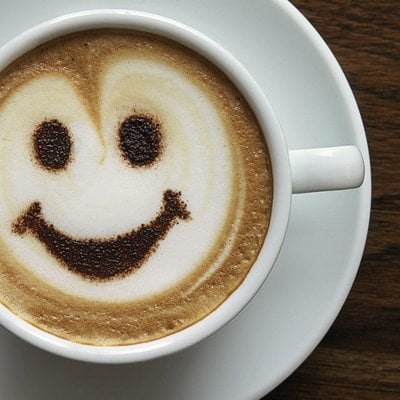 a photo of a coffee with smiley face art and how to speed up your metabolism after 40