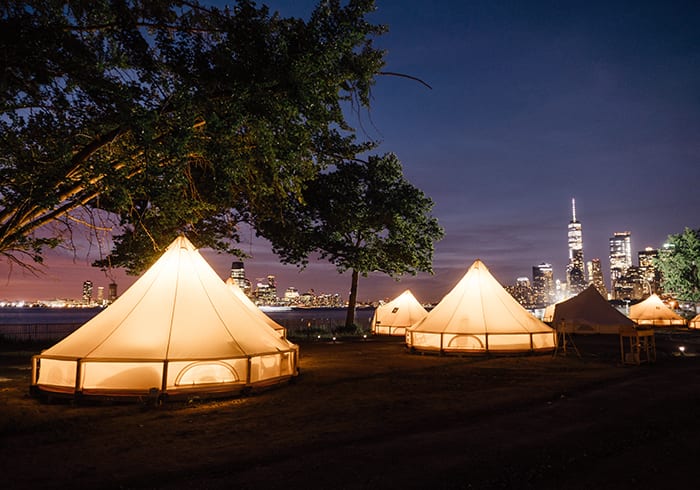 a photo of glamping teepees at night and 5 seriously cool glamping spots to visit in 2023