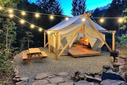 a photo of a glamping tent with twinkle lights and 5 seriously cool glamping spots to visit in 2023