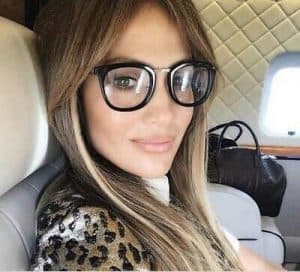 a photo of JLo wearing the Alchemist readers in Caviar and 5 trendy readers for 2023